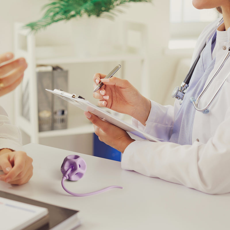 Doctor taking notes with a patient in a medical office setting with a Soma Flex® 45 in the foreground