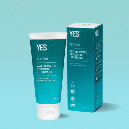 Tube and box of YES water-based personal lubricant on a light blue background