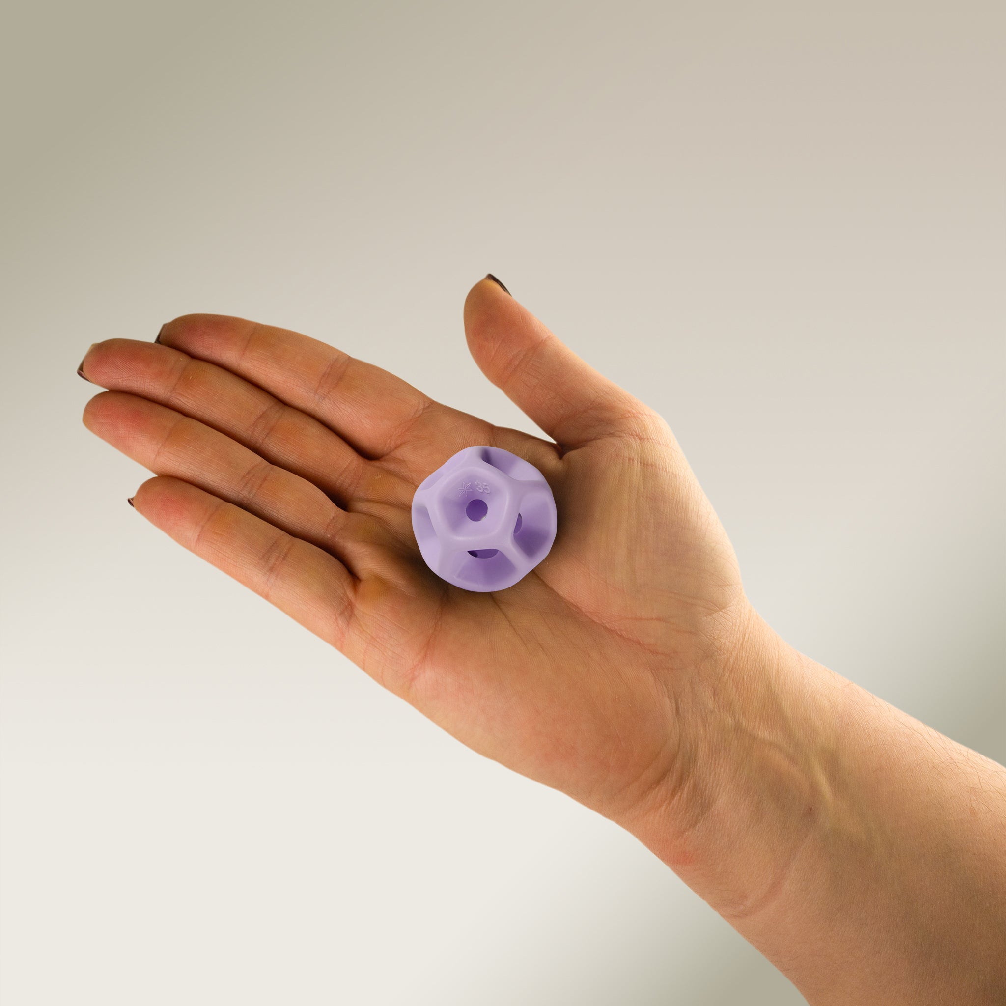 Hand holding a Soma Flex® 35 in the palm and against a plain background