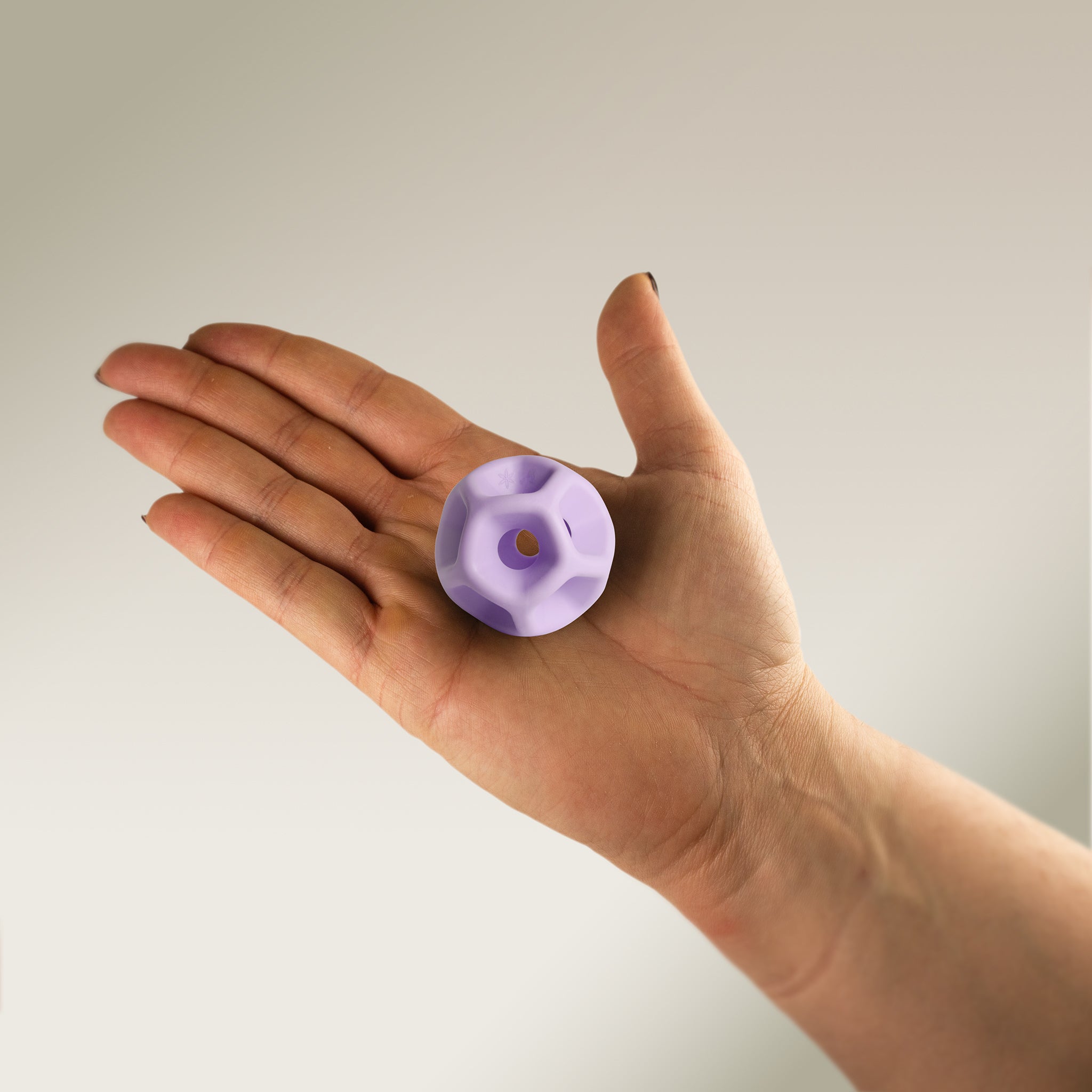 Hand holding a Soma Flex® 40 in the palm and against a plain background