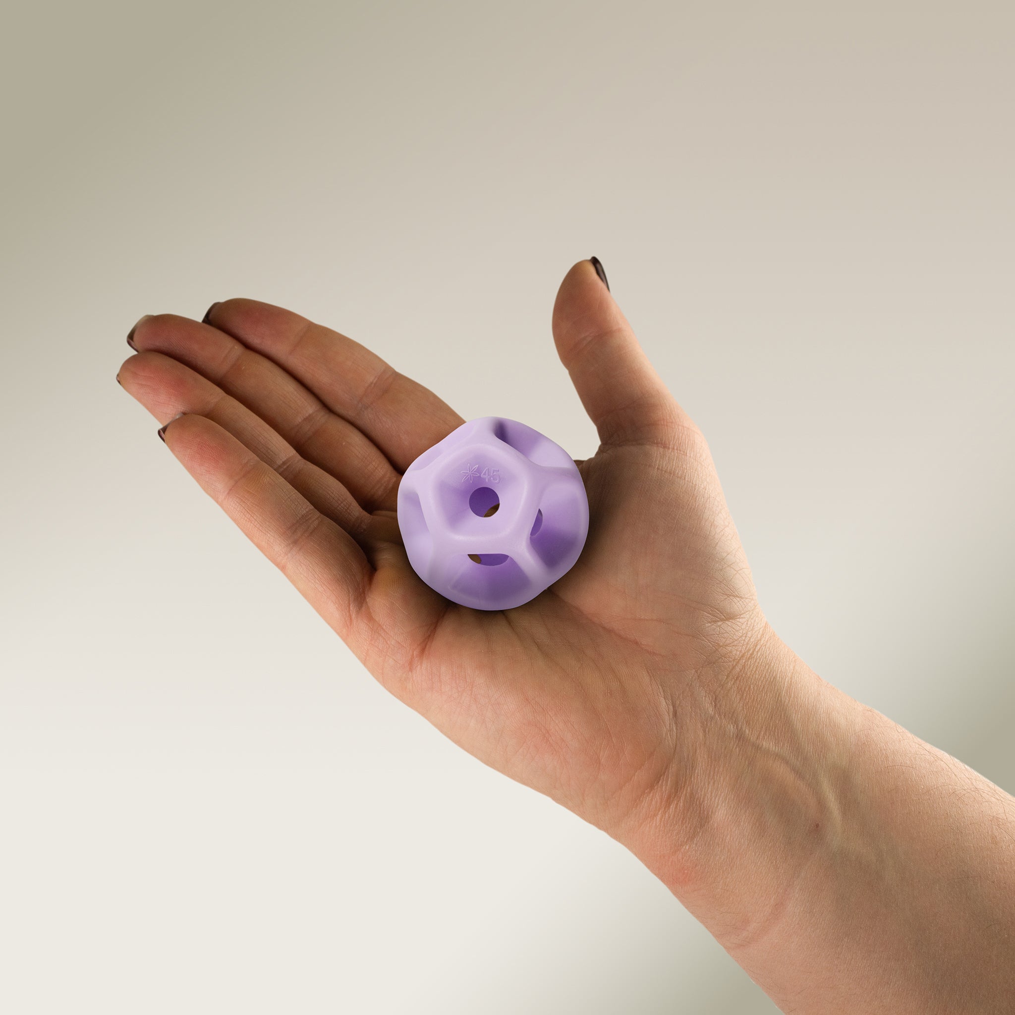 Hand holding a Soma Flex® 45 in the palm and against a plain background