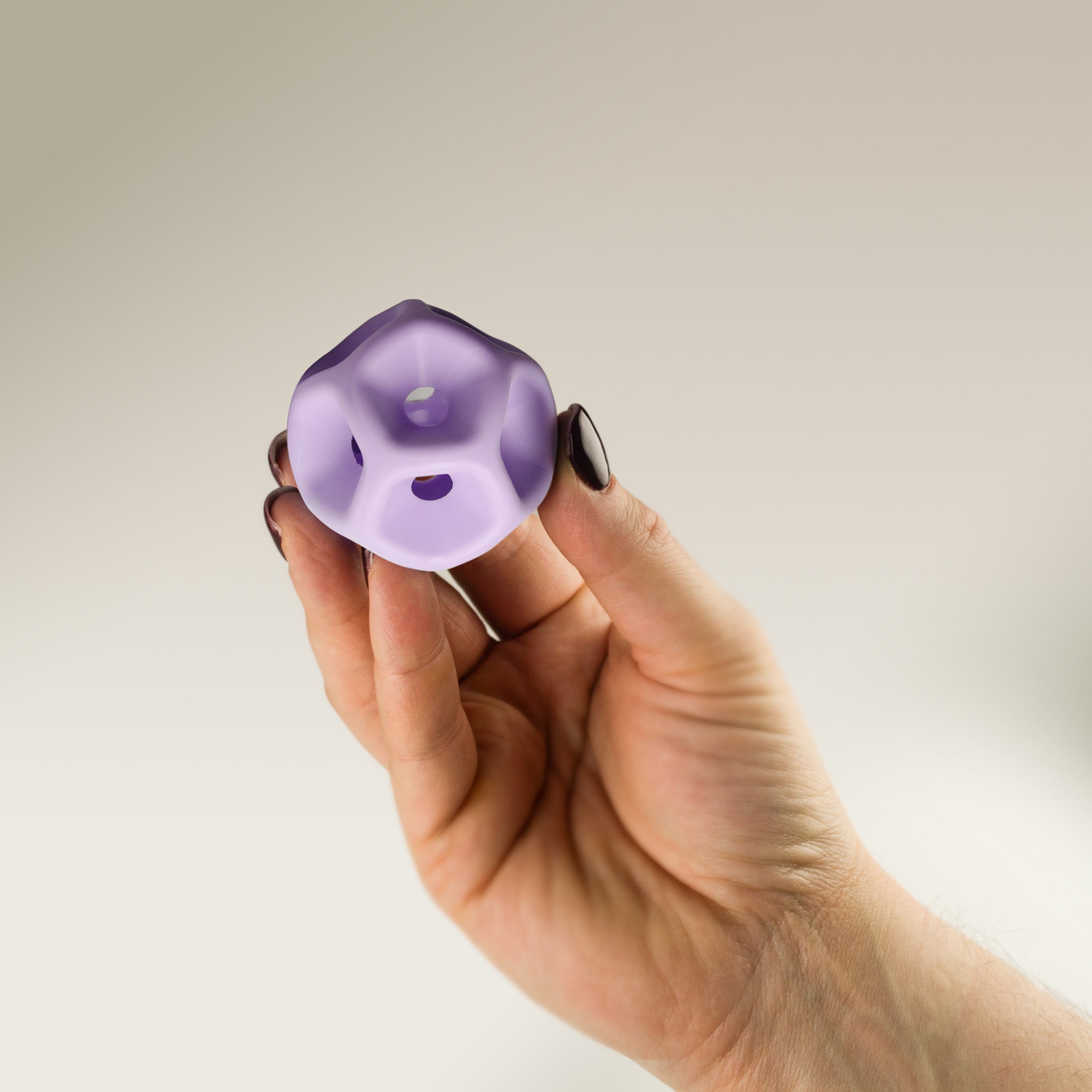 Hand holding a Soma Flex® 50 against a plain background