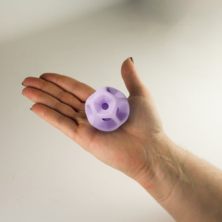 Hand holding a Soma Flex® 50 in the palm and against a plain background