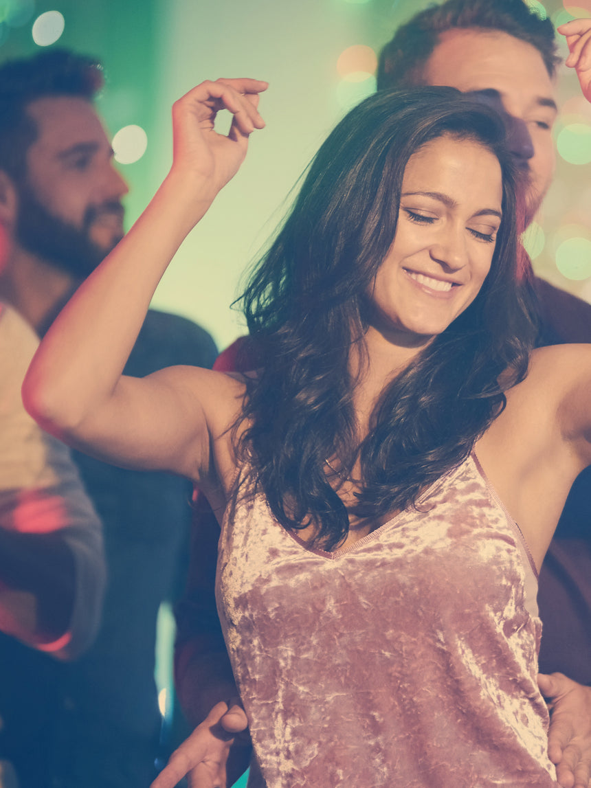 Woman dancing at a party with blurred background